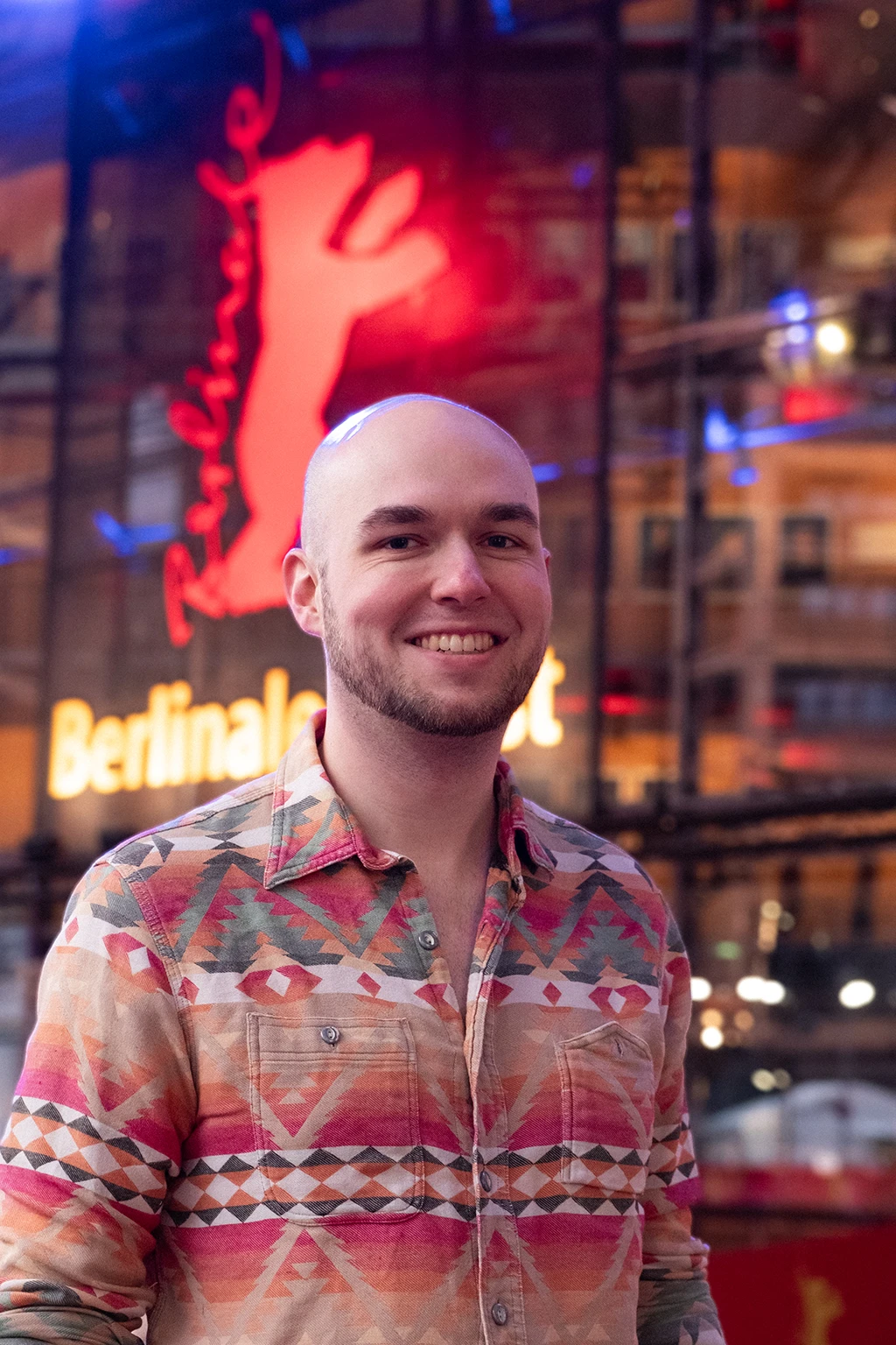 A man in a colorful shirt on the red carpet.